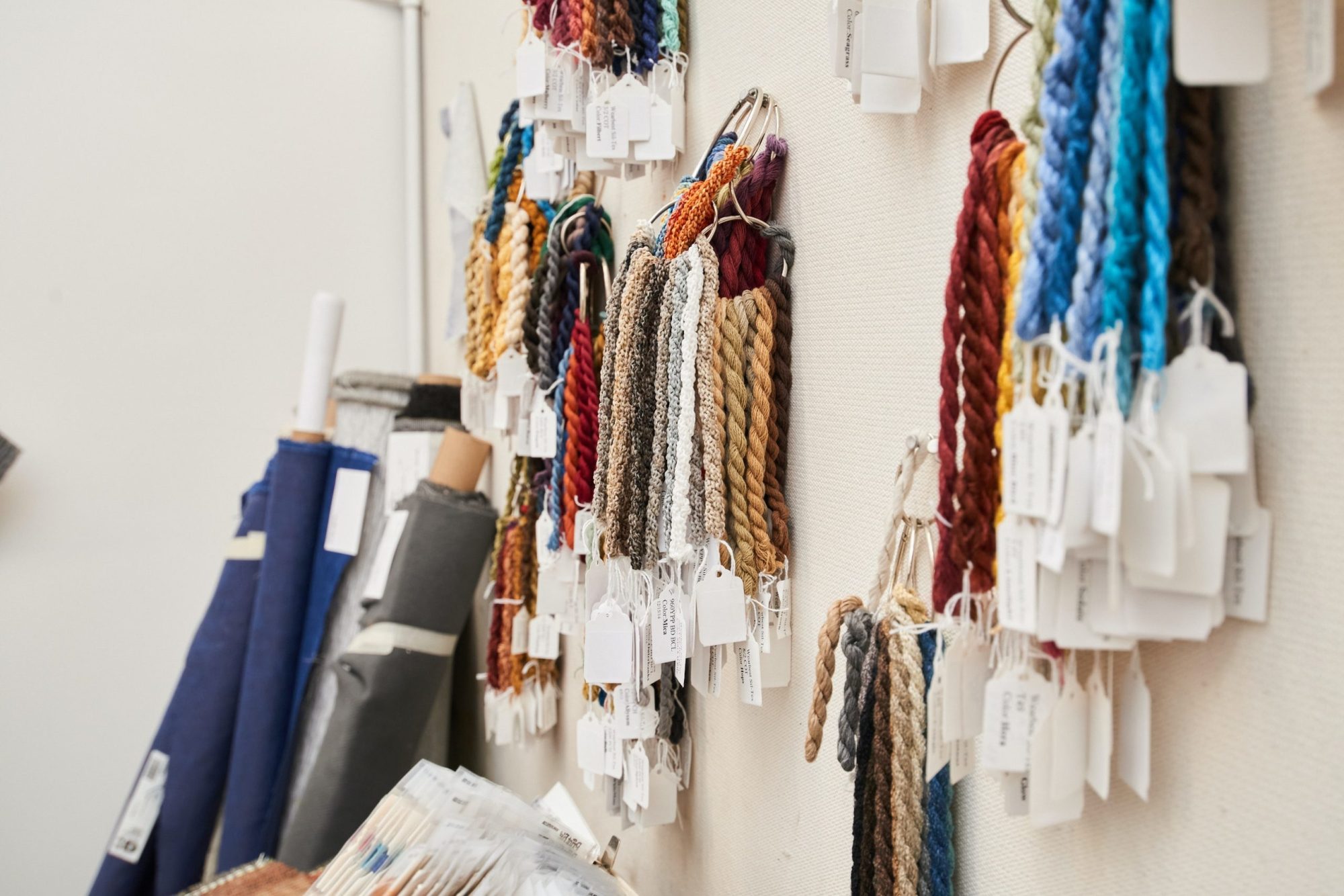 strands of fabric samples hanging on the wall