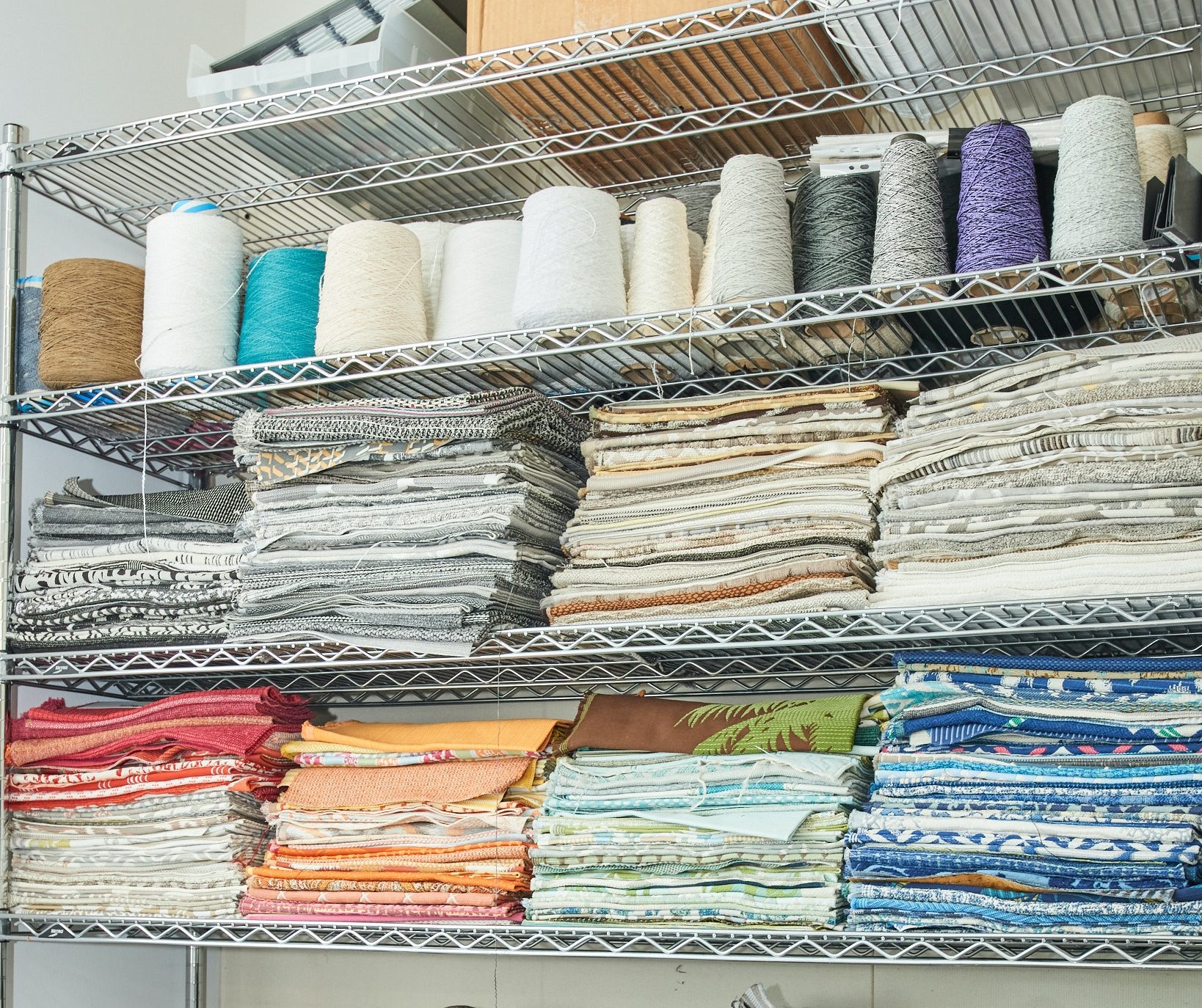 Swavelle fabrics and threads on a wire shelf